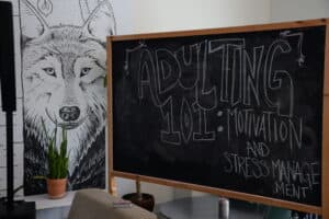 A reserved space and a chalkboard in the AC Hub that illustrates Adulting 101: Stress Management and How to Stay Motivated. Photo credit: Isabella Disley