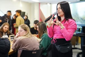 Samantha Therrien, the event officer at Algonquin College, gives a speech for the Valentine's Day Social event at AC Hub and goes over the bingo game instructions.