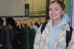 Maddy MacDonald, a student in the business and marketing program at the booth looking at the hoodie options.