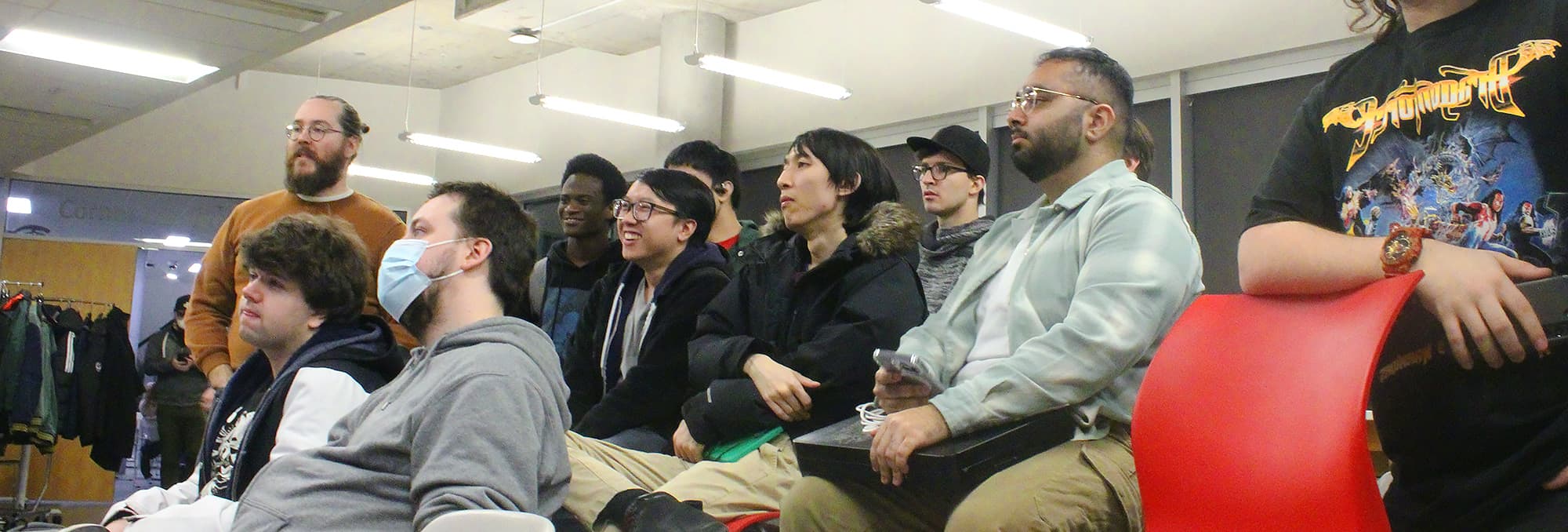 Competitors gather around to watch the Under Night In-Birth 2 bracket at the event.