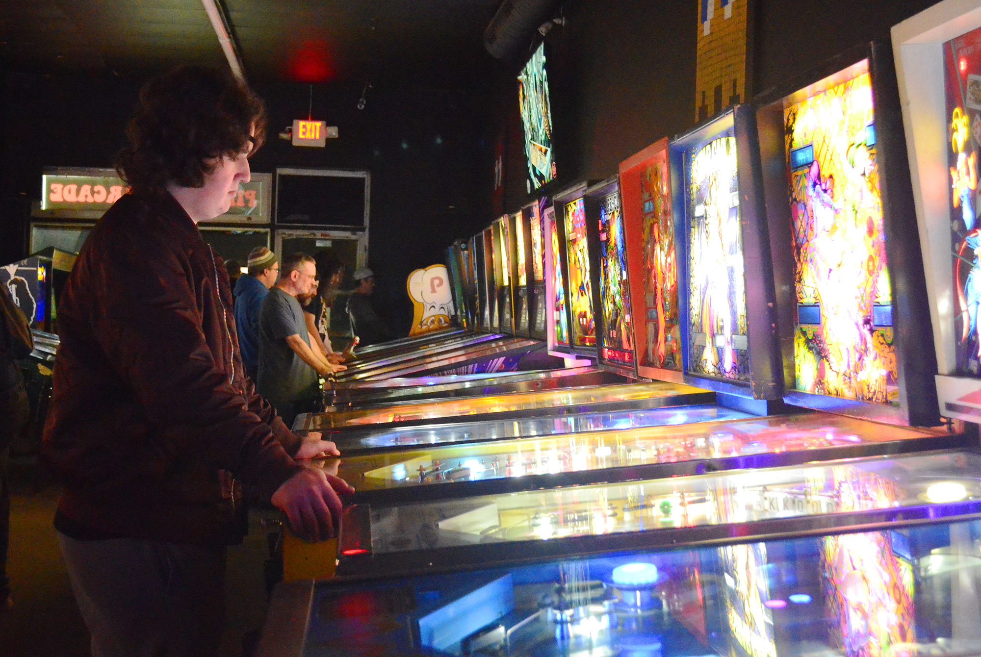 Dylan McGowan attempts to set a high score on an older pinball machine.