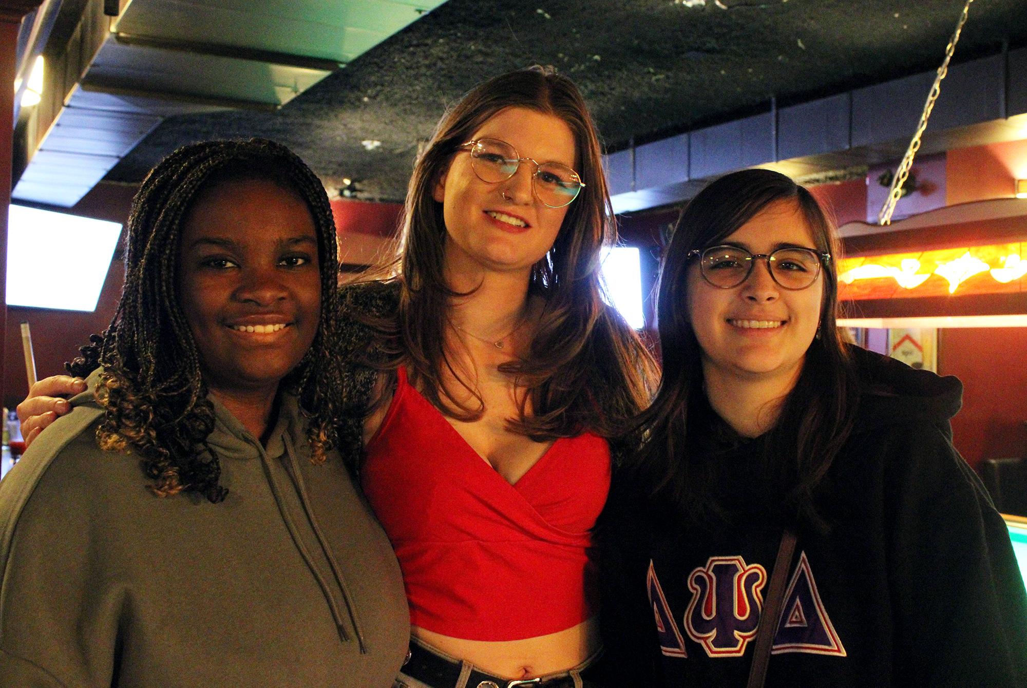 Algonquin College students and Delta Psi Delta sisters (from left to right) Karine Joseph, Jacquelyn Mills and Adriana Cote during the pool tournament at MacLaren's on Elgin on Feb. 29.