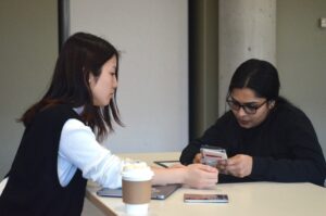 Reshma Ravindran (right) helping Yuki Lida (left) with the tax filing process at the student led tax workshop