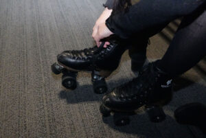 Ella Kho lacing up her skates before she goes on the rink.