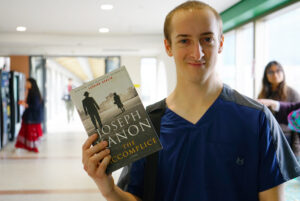 Matthew Bowman, a Level 1 practical nursing student at Algonquin College, opened his mysterious book at the book sale event.