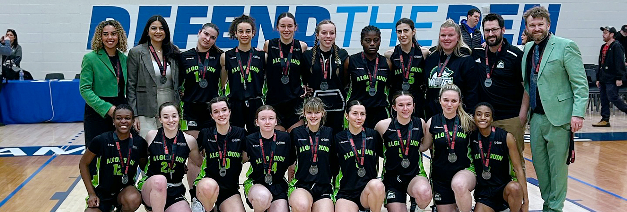 The Wolves women's basketball team and coaching staff pose with their their silver medals at OCAA final game in Sarnia, Ont. March 3.