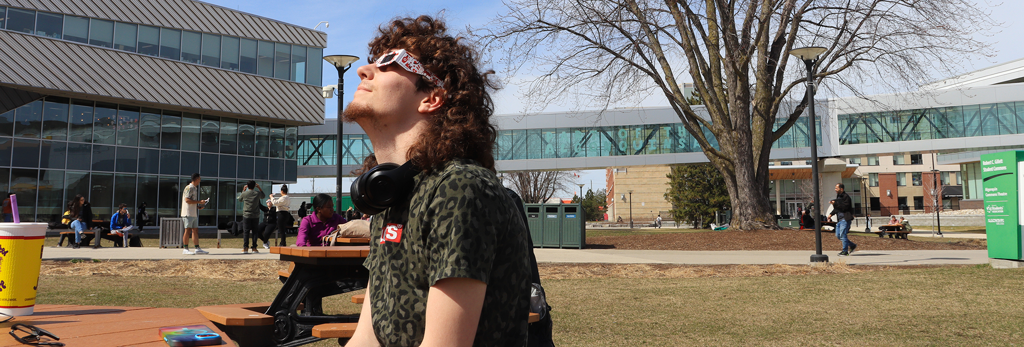 Izach Carberry, a game development student, watches the beginning of the eclipse with his friends.