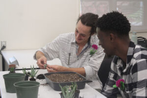 Ethan Walls (left) and Jonathan Mihigo (right) planting succulents as part of the event.