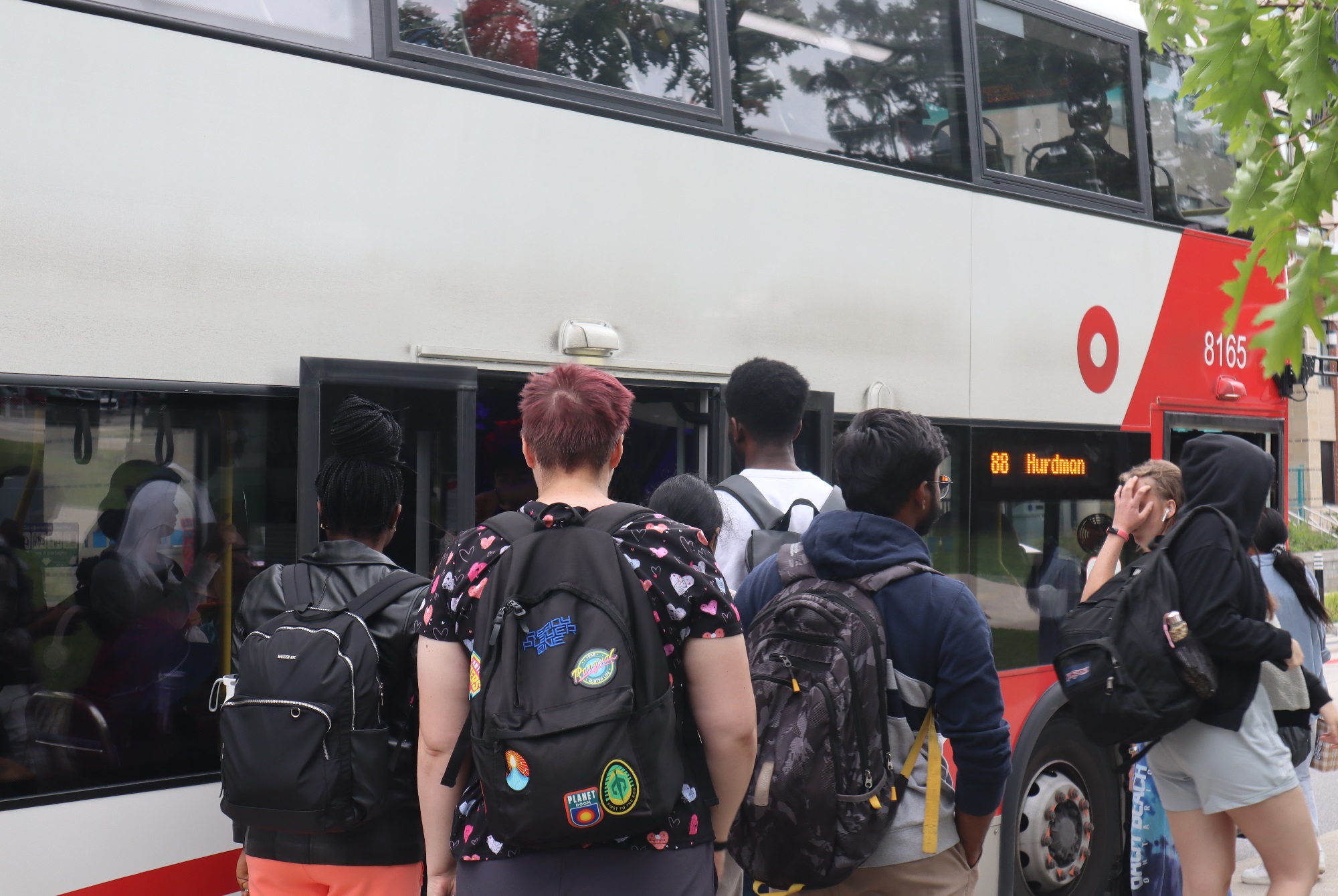 Students board an outbound bus at one of Algonquin's two bus stops, across the street from residence