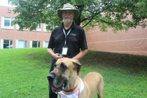 Rod Burns and Apollo from St. John Ambilance Therapy Dogs at the Paws and Stress booth at the fest.