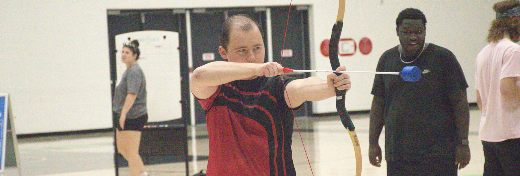 Algonquin student shooting arrow.