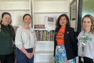 Four of the organizers pose by the bookshelf early on Sept. 26. L-R: Nina Newman, Joanne Cairns, Anita Tenasco and Lauren Larocque.