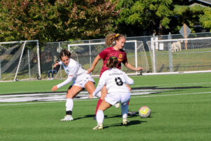 Players of both teams fighting to get the possession of the ball.