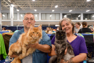 Paul and Sherri Robicheau holding Fen (left) and William (right) at the Ottawa Cat Show in the Curling Rink of the Nepean Sportsplex on Sept. 28.