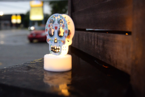 A small white calavera light surrounded by raindrops at the Nepean Night Market on Oct. 6. Photo credit Isabella Disley