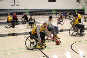 The students embarked on a practice competition to try out the sport of wheelchair basketball in the gym, which wasn't easy.