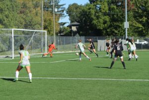 Olivia Bradley moves in for a shot against Centennial goalie Jordyn Chrons-Slaght. Bradley was also named an Athlete of the Week this week by the Students Association.