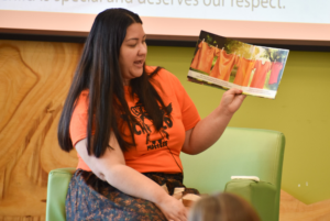 Professor write reads The Orange Shirt story by Phyllis Webstad to the children from The Early Learning Center.