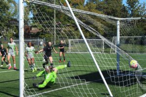 Algonquin goalie Paige King hits the ground after trying to stop Soledad Vazquez-Cicutto's shot.