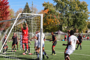 Fanshawe's Dylan DaSilva jumps to secure a corner-kicked ball.