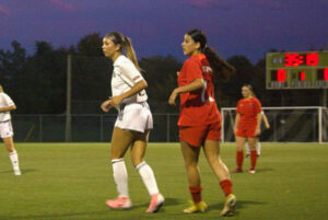 Rivalry and respect: Players from the Algonquin Wolves and Seneca Sting stand side by side during the match.