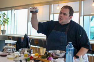 Chef Chris Tremblay presents his homemade salad dressing, as he shares his culinary tips with students at the Kitchen Skills 101 workshop.