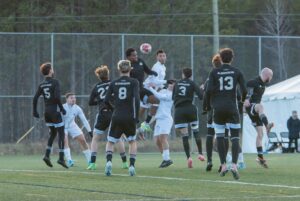 Gershom Dupuy about to strike a header.