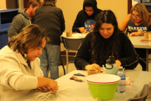 Students making traditional birch baskets.