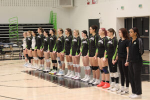 Algonquin Wolves women's volleyball team, standing for the National Anthem