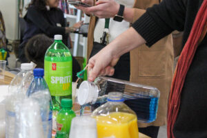 An Umbrella Project staff member is making drinks for attendees