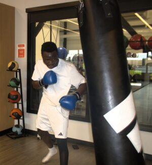 "Joseph Ilunga balances boxing with playing varsity football for the Wolves."