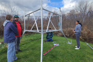 The weather station team and some spare hands working to put together the weather station on Algonquin College's Pembroke campus.