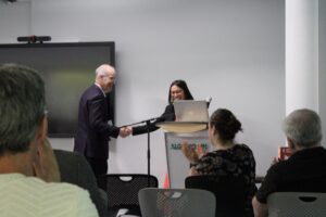 Morgan Lim being welcomed to the stage by Phillip Dawe