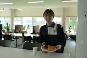 Solomon Beals enjoying a bagel, thinks Algonquin should do more events like these.