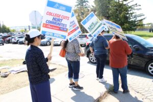 Protesters on Navaho Drive in front of the parking lot by A-building.