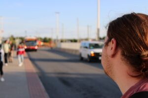 Adam Ames eyeing the 87 bus as it parks at Baseline station. Ames says the transit system isn't as good as it was three years ago.