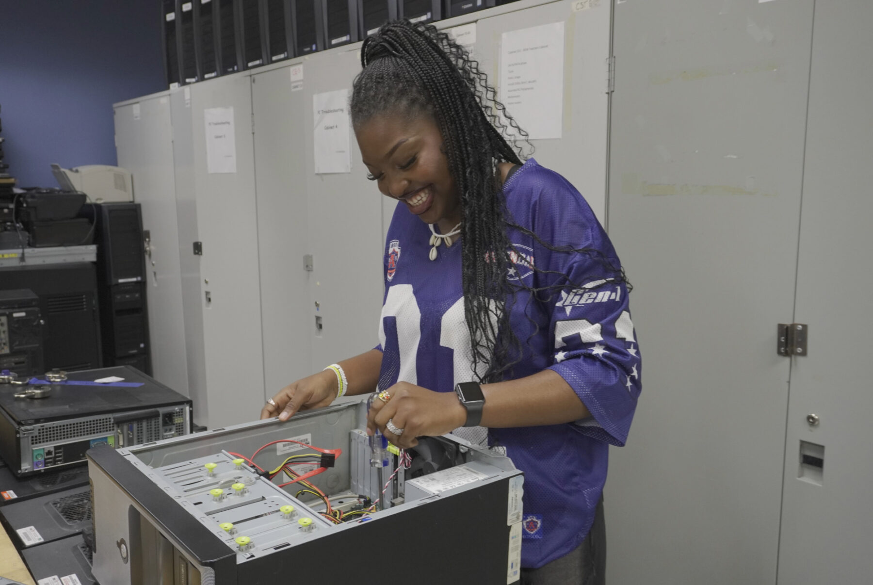 Opetorera Afinmo assembles a computer during a hands-on IT lab session.