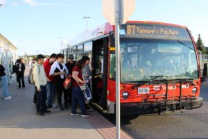 A group of people boarding the 87 to Tunney's Pasture.