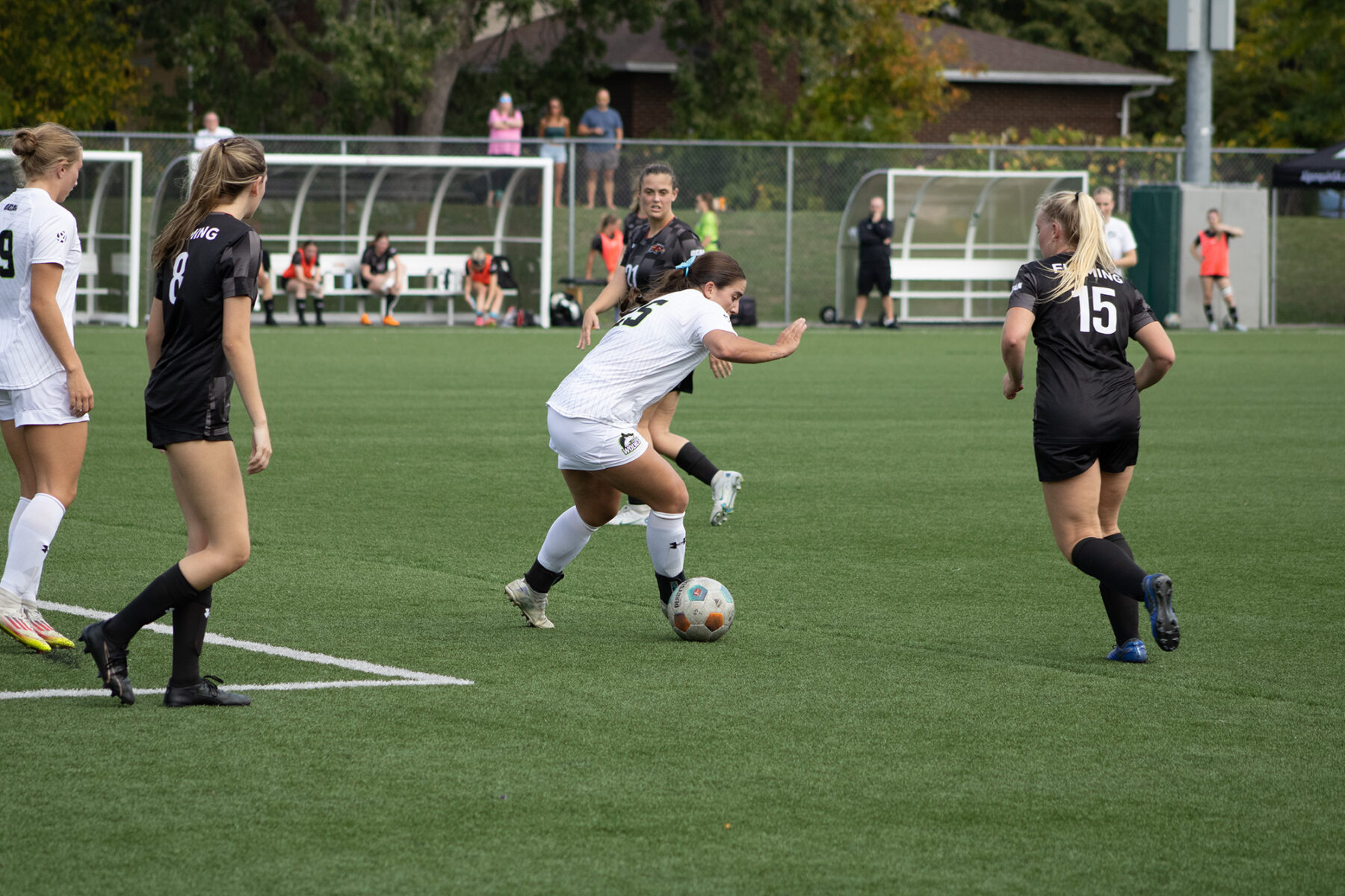 Alex Aubin dribbles past defenders on the edge of the box at Algonquin Sports Field on Sept. 27.