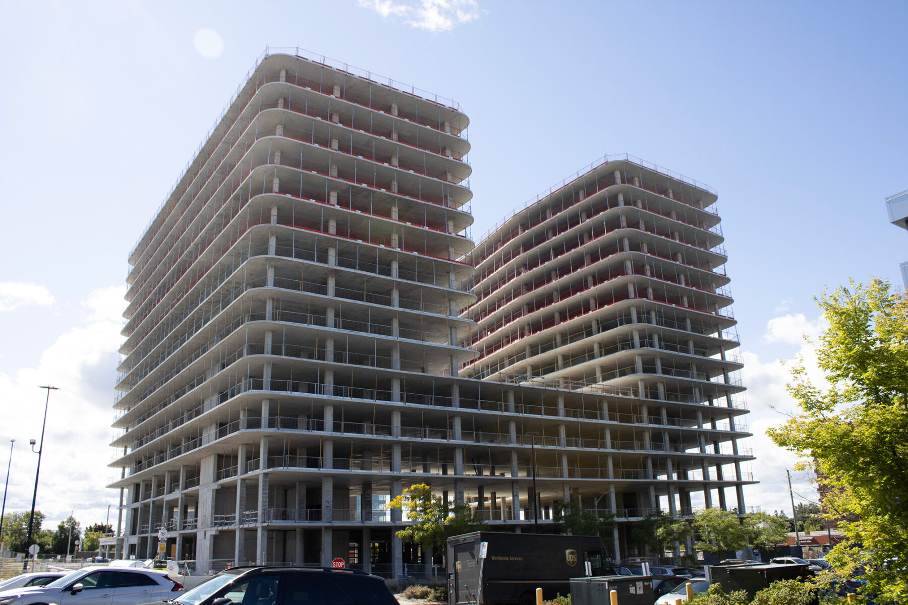 Two unfinished residential towers stand beside the Laurentian Plaza strip mall at Baseline Road and Clyde Avenue.