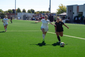 Alex Aubin, No.25 for the Wolves, moves the ball towards the goal at the Z building field against the Thunderwolves
