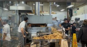 Inside the heart of Kettleman's, where workers are cooking in the open fire and others are bagging them up.