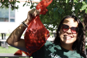 Celeste Romero holding up her bag of crabapples at the event on Sept. 9