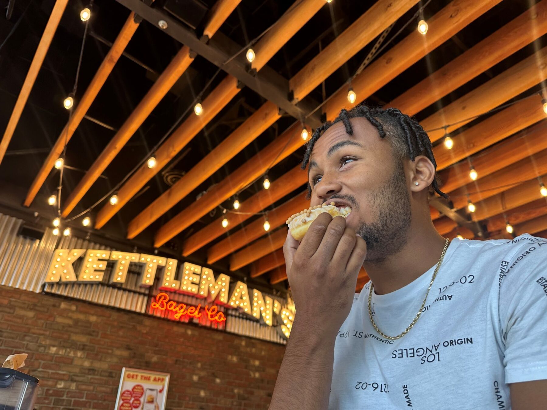 Kieron Jackson eats a salted caramel donut at Kettleman's.