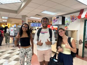 From left to right, Zanti Murray, Kieron Jackson, and Saige Boston pose in the cafeteria to approve the off-campus choices on this list.