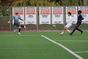 Alessandro Vivolo races towards the ball as the Bruins goalie kicks it away.