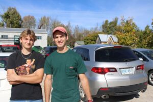 Two students stood in parking lot.
