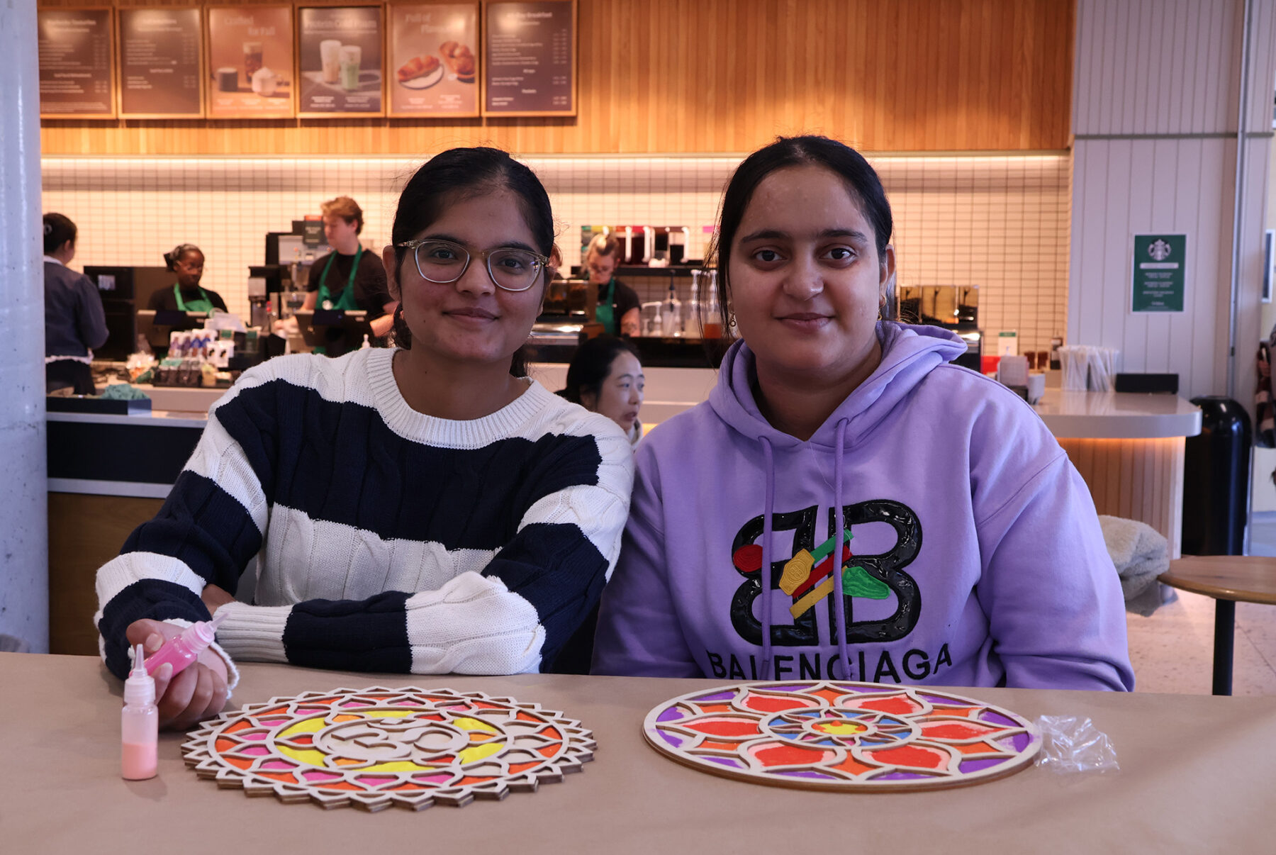 Students Jasleen Kaur (left) and Harsimranjeet Kaur took part in filling wooden outlines with coloured sand, mimicking the traditional art of rangoli.