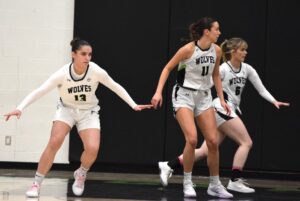 Former players Piper Hatherall (left), Libby Hirst and Sydney Moore (right), take defensive positions during a game against Centennial Colts on Jan. 11, 2025