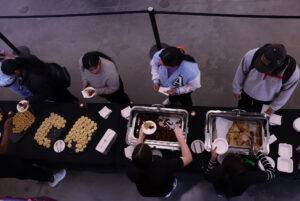Members of the Students' Association served besan laddoo, nankhatai, vegetable pakora and samosas (left to right).